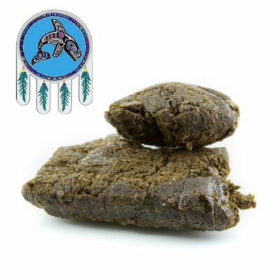 A piece of brownie topped with a feather, Jamaican Gum Hash